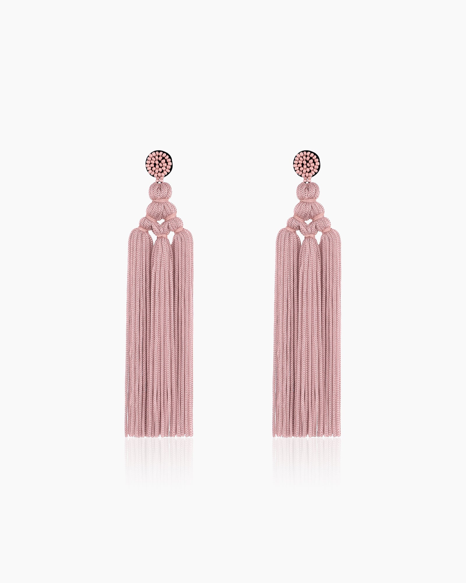 Earrings with extra-long, silky, blush-pink tassels cascading from intricately knotted tops