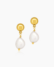 Earrings with a sculpted gold stud paired with an oversized freshwater pearl for a modern, sophisticated look