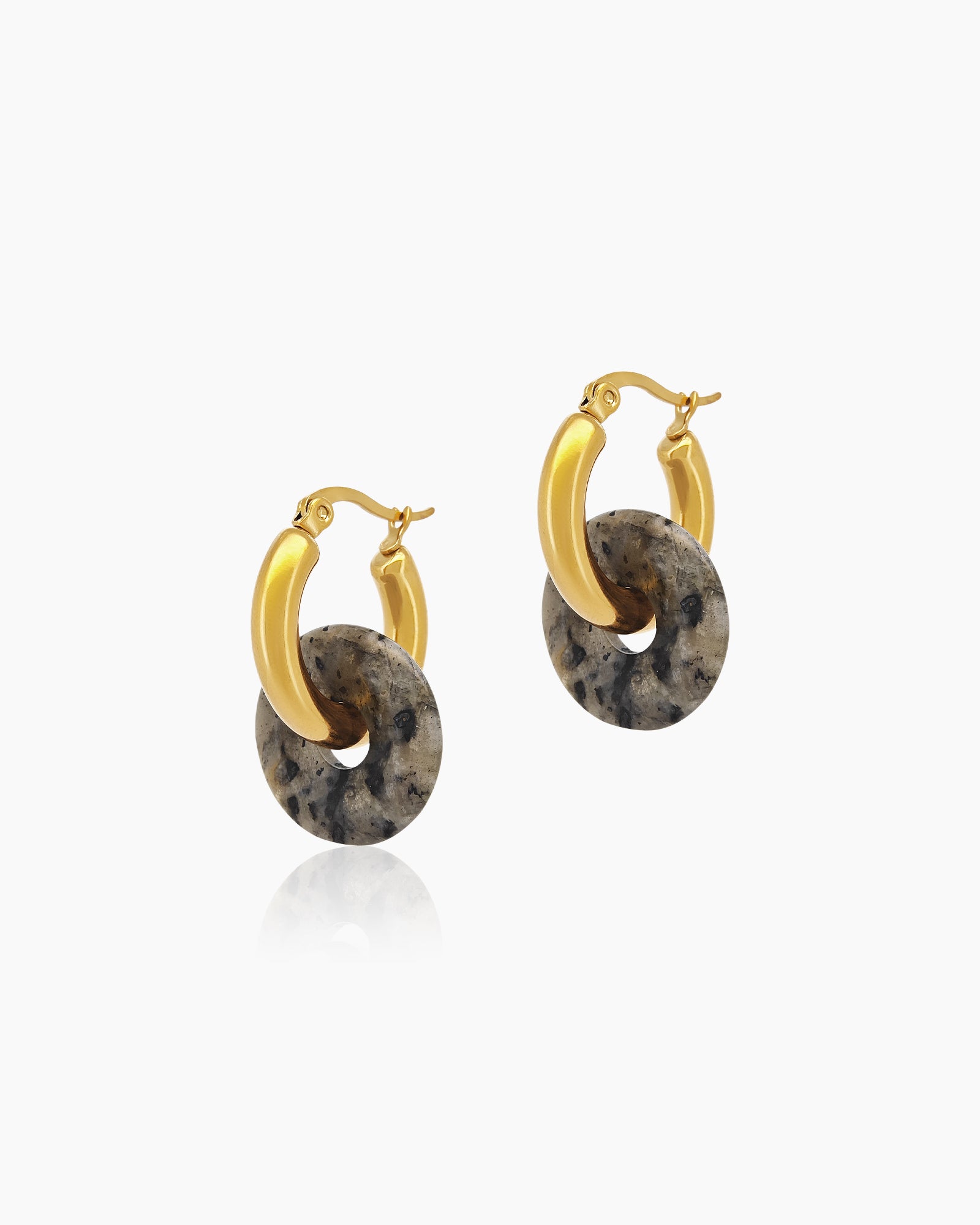 Chunky gold-tone hoops paired with natural black quartz drops, each uniquely marbled with organic veining