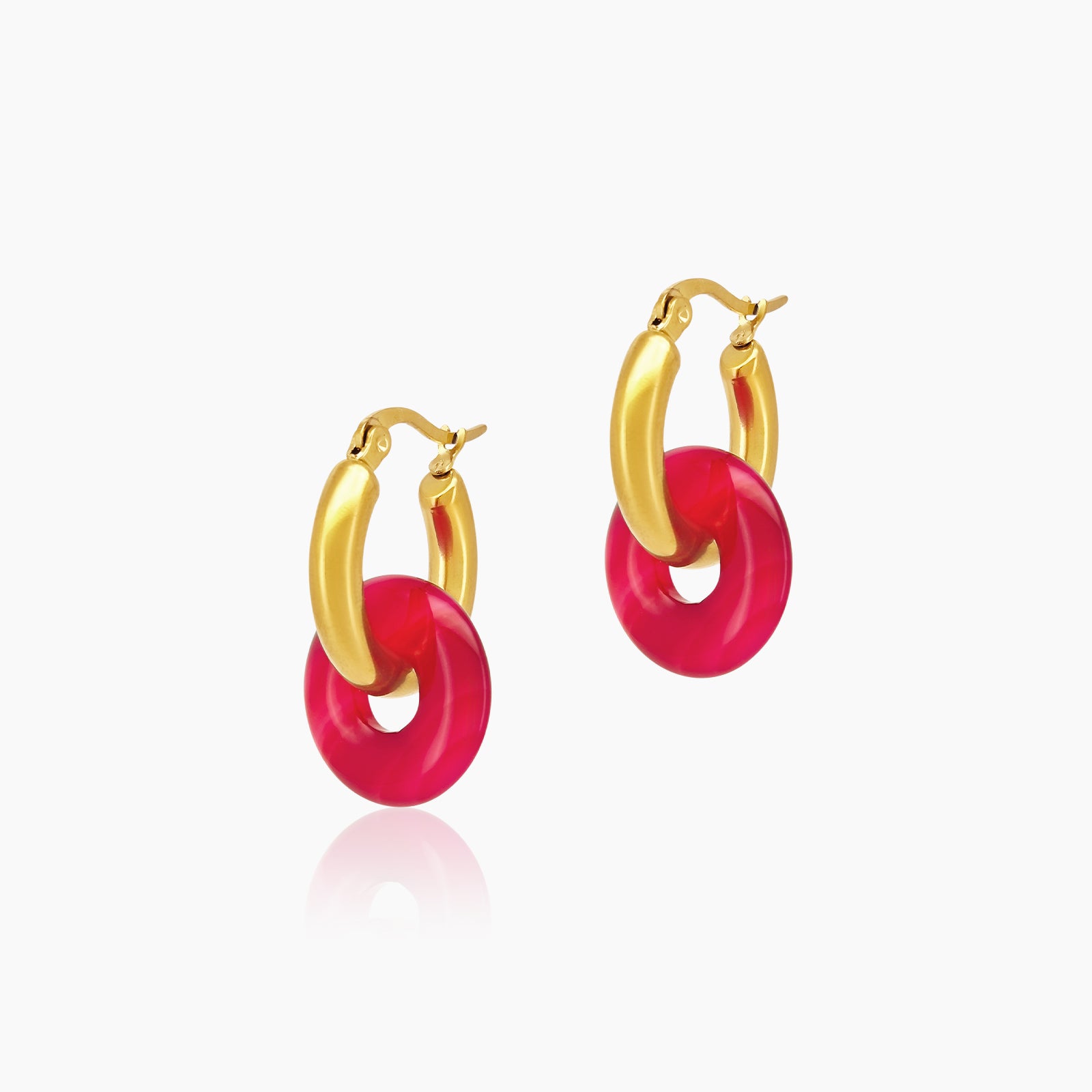 Chunky gold-toned huggie hoops featuring fuchsia natural carnelian donut charms for a playful look