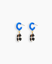 Statement earrings with a glossy cobalt blue hoop and a black-and-white hand-painted shell drop