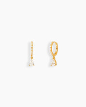 White drop earrings with a slim gold-tone hoop encrusted in pavé-set zircons and a pear-shaped drop