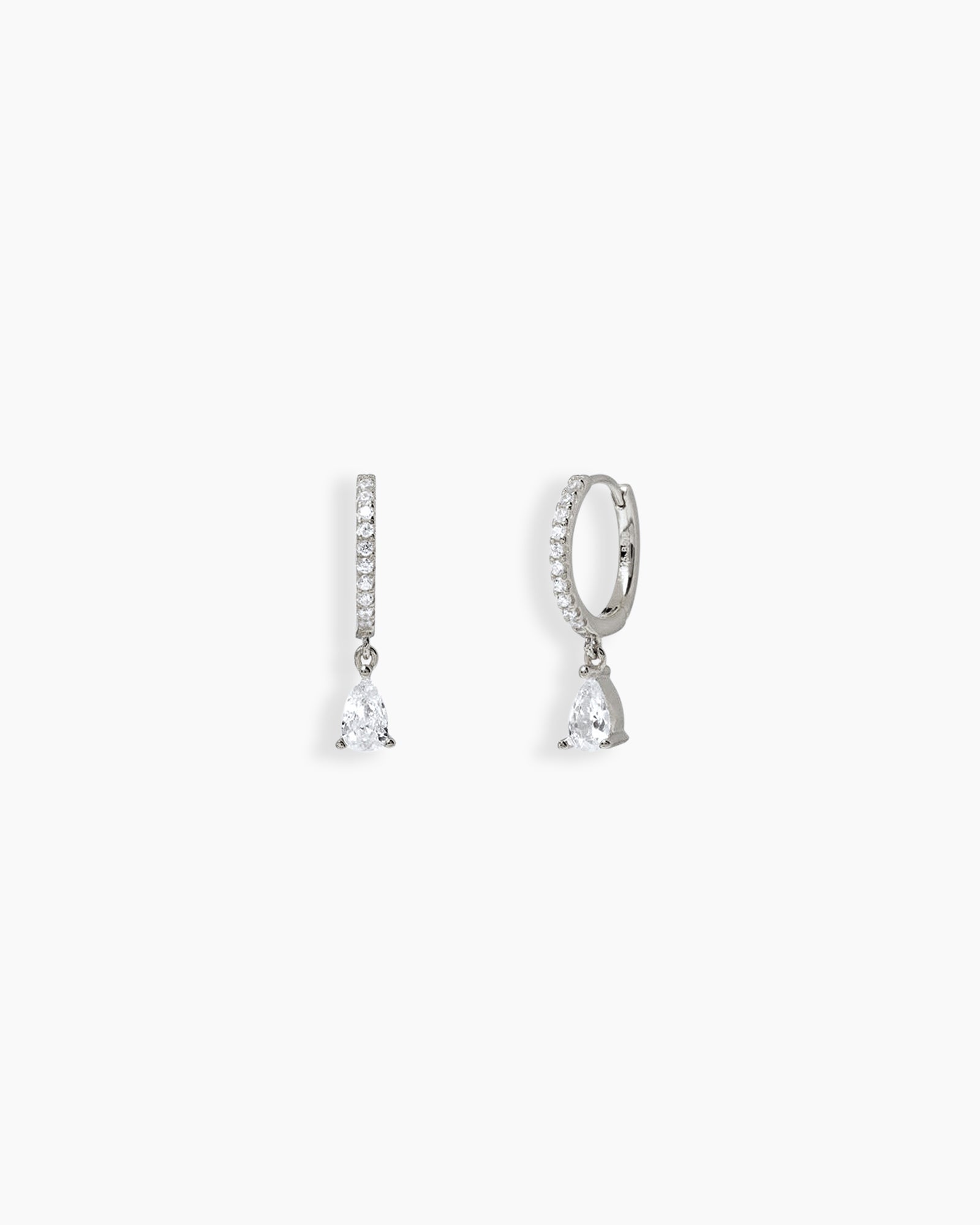 Silver drop earrings with a slim silver-tone hoop encrusted in pavé-set zircons and a pear-shaped drop