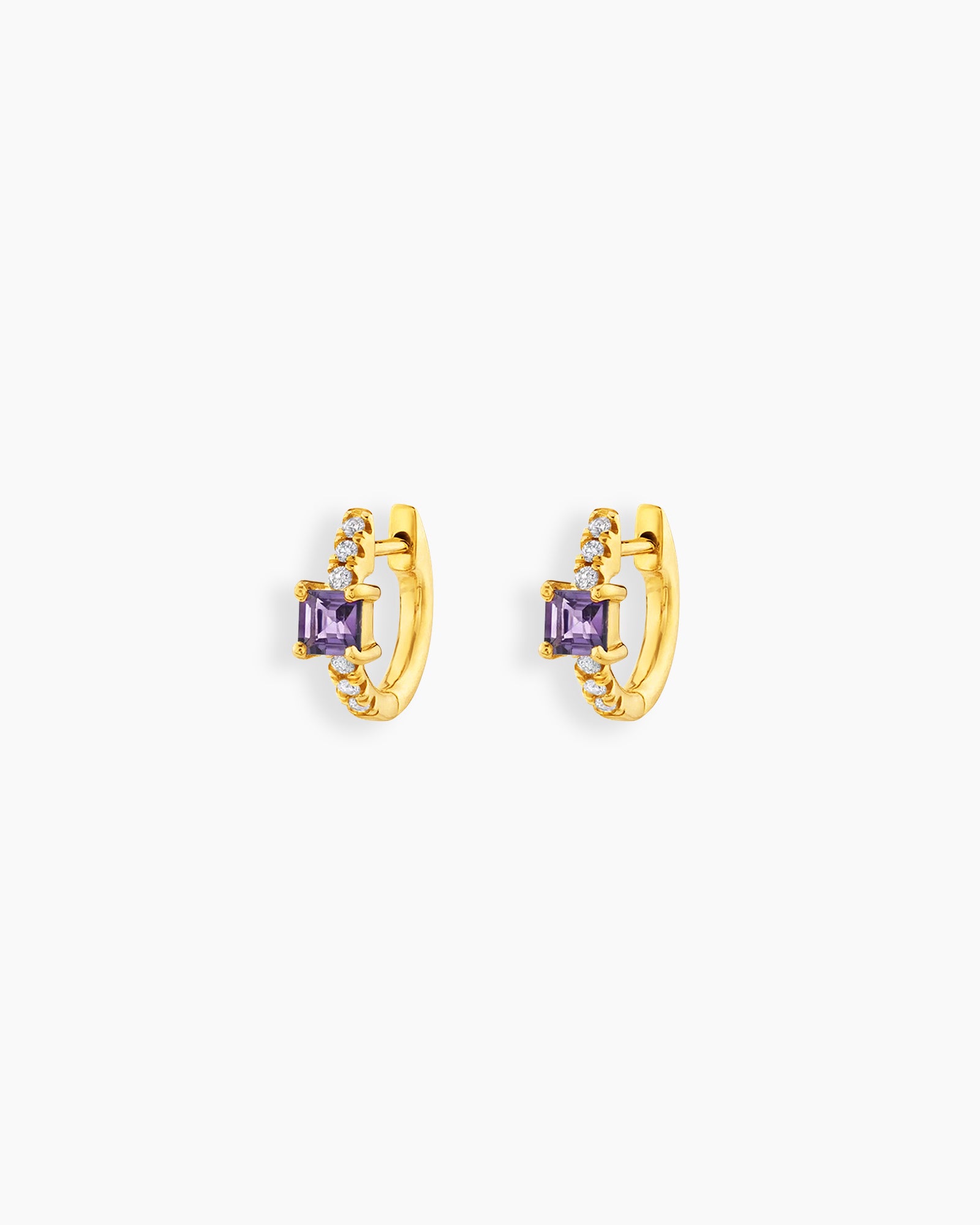 Purple huggie earrings with a sleek gold-tone hoop, a baguette-cut center stone, and a delicate arc of pavé