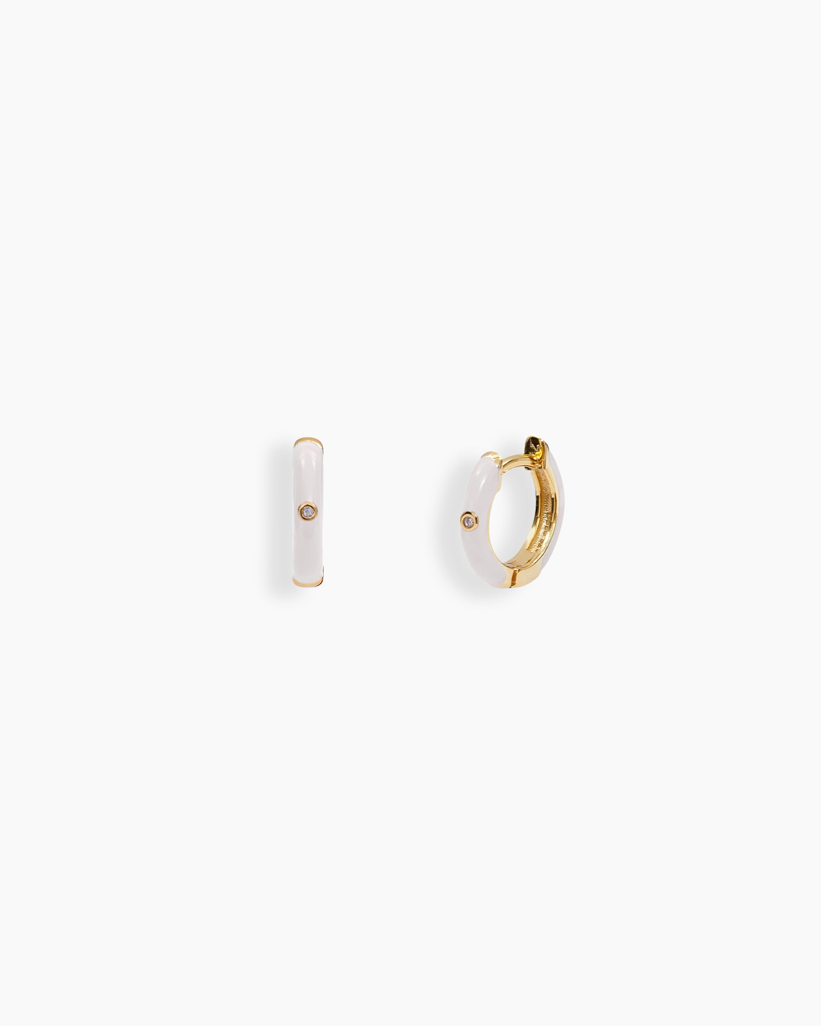 White mini hoops coated in glossy enamel and accented with a single sparkling zircon for a playful twist