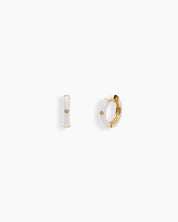 White mini hoops coated in glossy enamel and accented with a single sparkling zircon for a playful twist