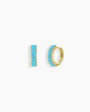 Turquoise-blue huggie earrings with a row of baguette-cut zircon stones in a sleek channel setting