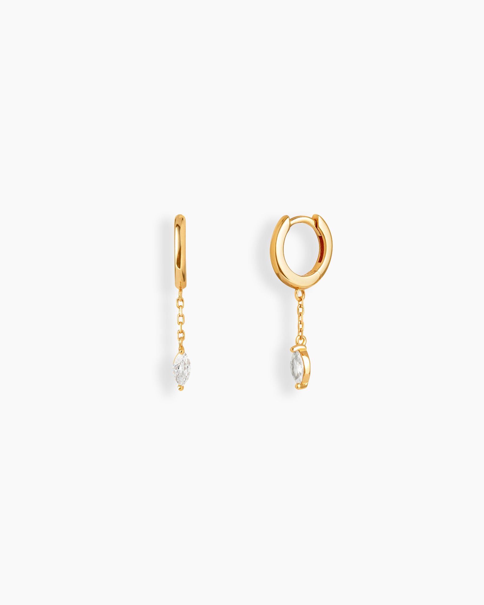 Gold drop earrings with polished huggie hoops, a fine chain drop, and a marquise-cut zircon stone
