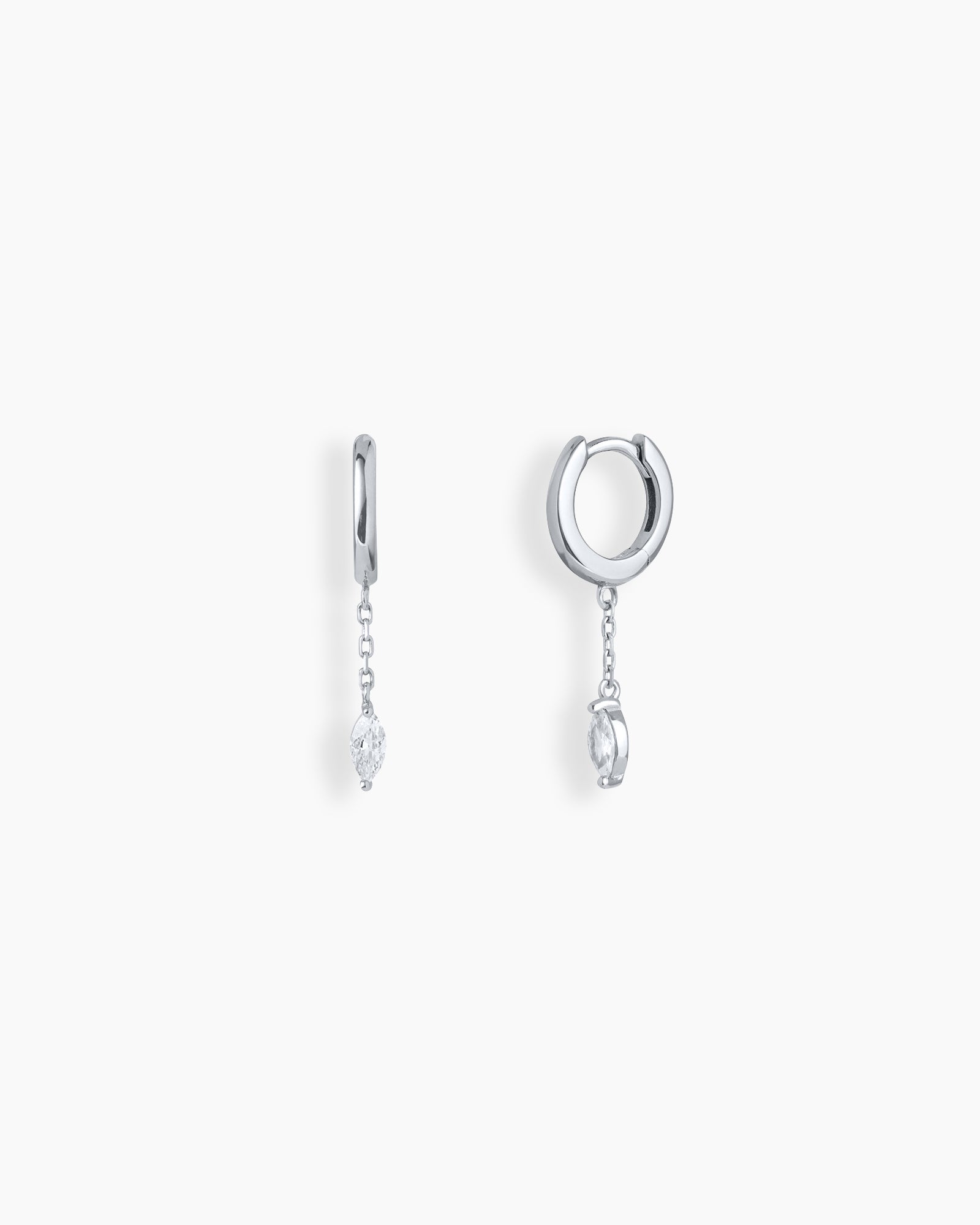 Silver drop earrings with polished huggie hoops, a fine chain drop, and a marquise-cut zircon stone