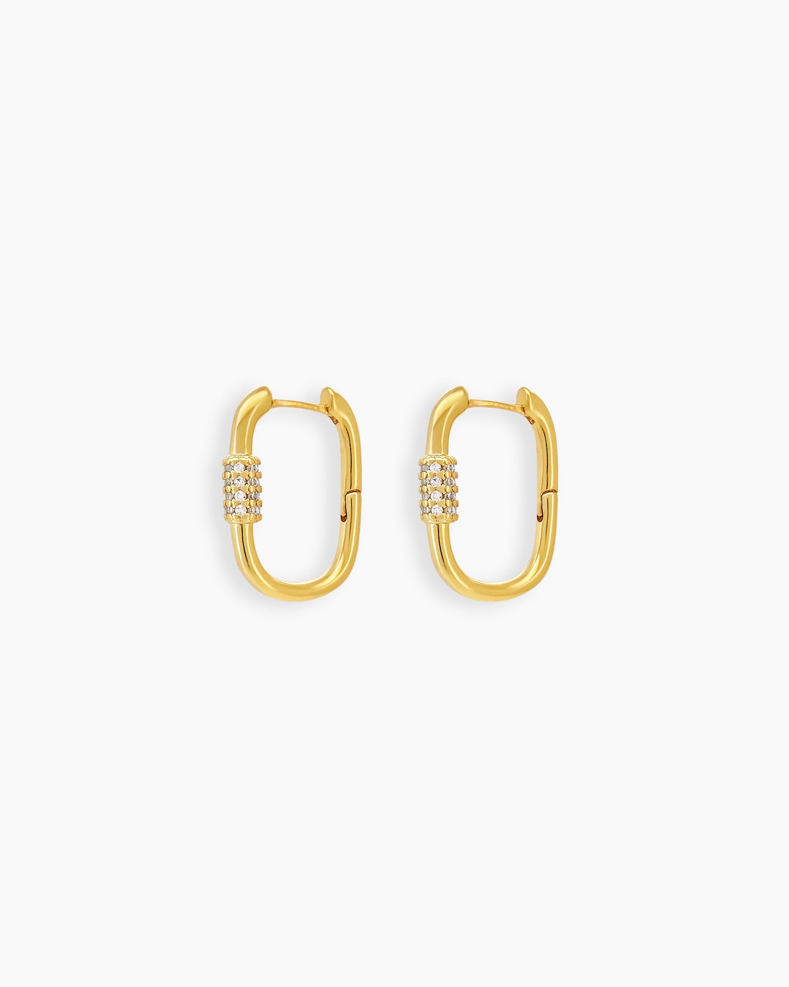 Gold carabiner-style earrings with a bold oval shape and a center band of clear zircon stones