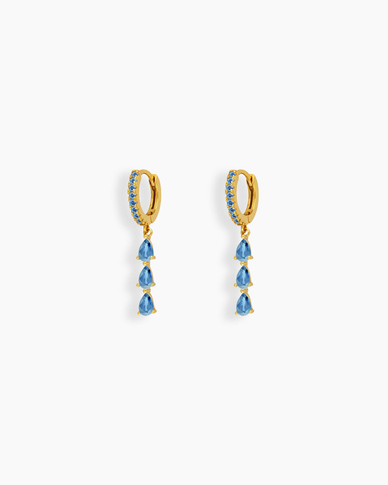 Light-blue drop earrings with three delicately suspended pear-shaped zircon stones that sway gracefully