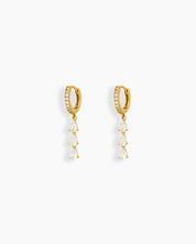 White drop earrings with three delicately suspended pear-shaped zircon stones that sway gracefully