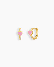 Huggie earrings with a glossy blush enamel heart at the center and delicate zircon accents tracing the hoops