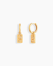 Gold huggie hoops with rectangular drops engraved in a dreamy cosmic motif of moons and stars
