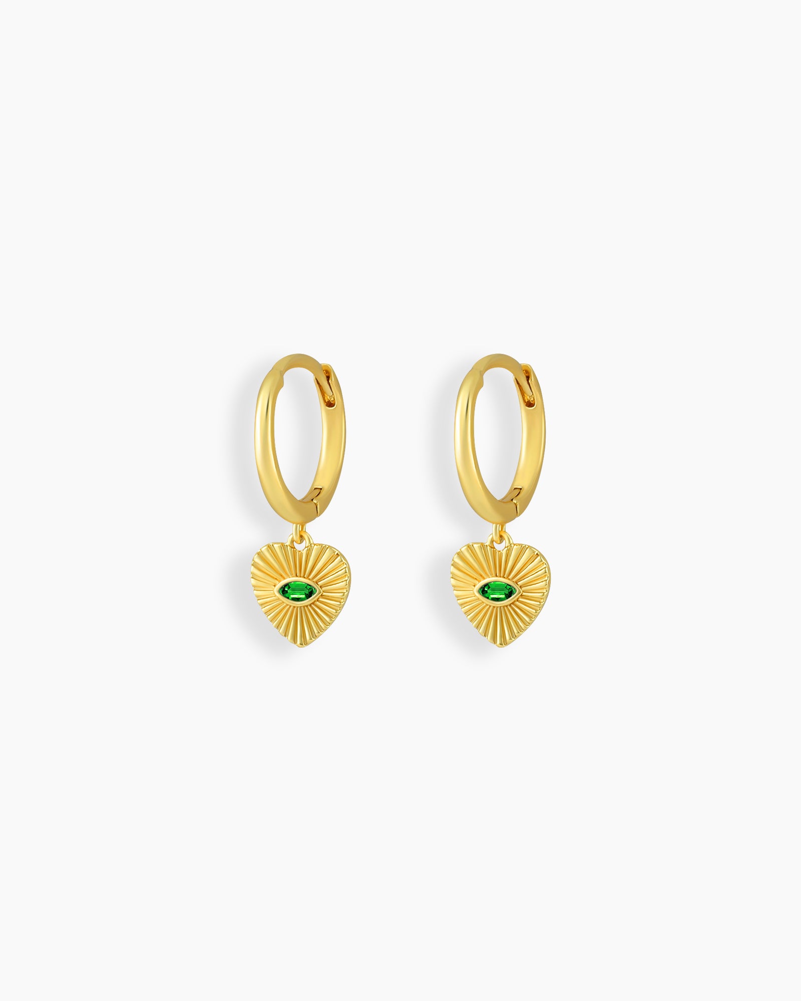 Polished gold-tone huggies anchored by textured heart-shaped drops with a central green zircon