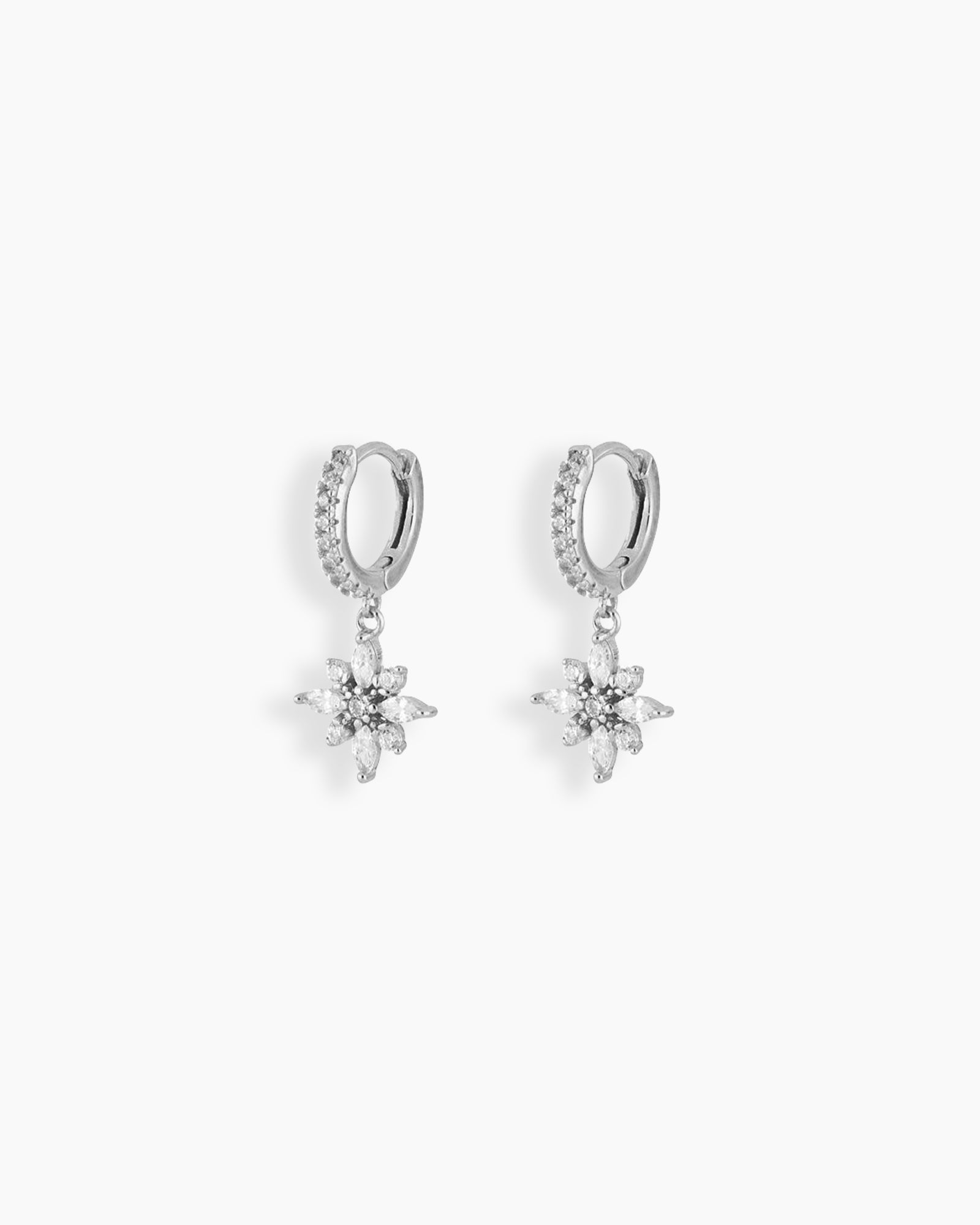 Silver huggie hoop earrings with a dainty flower-shaped charm crafted from marquise and round white zircons