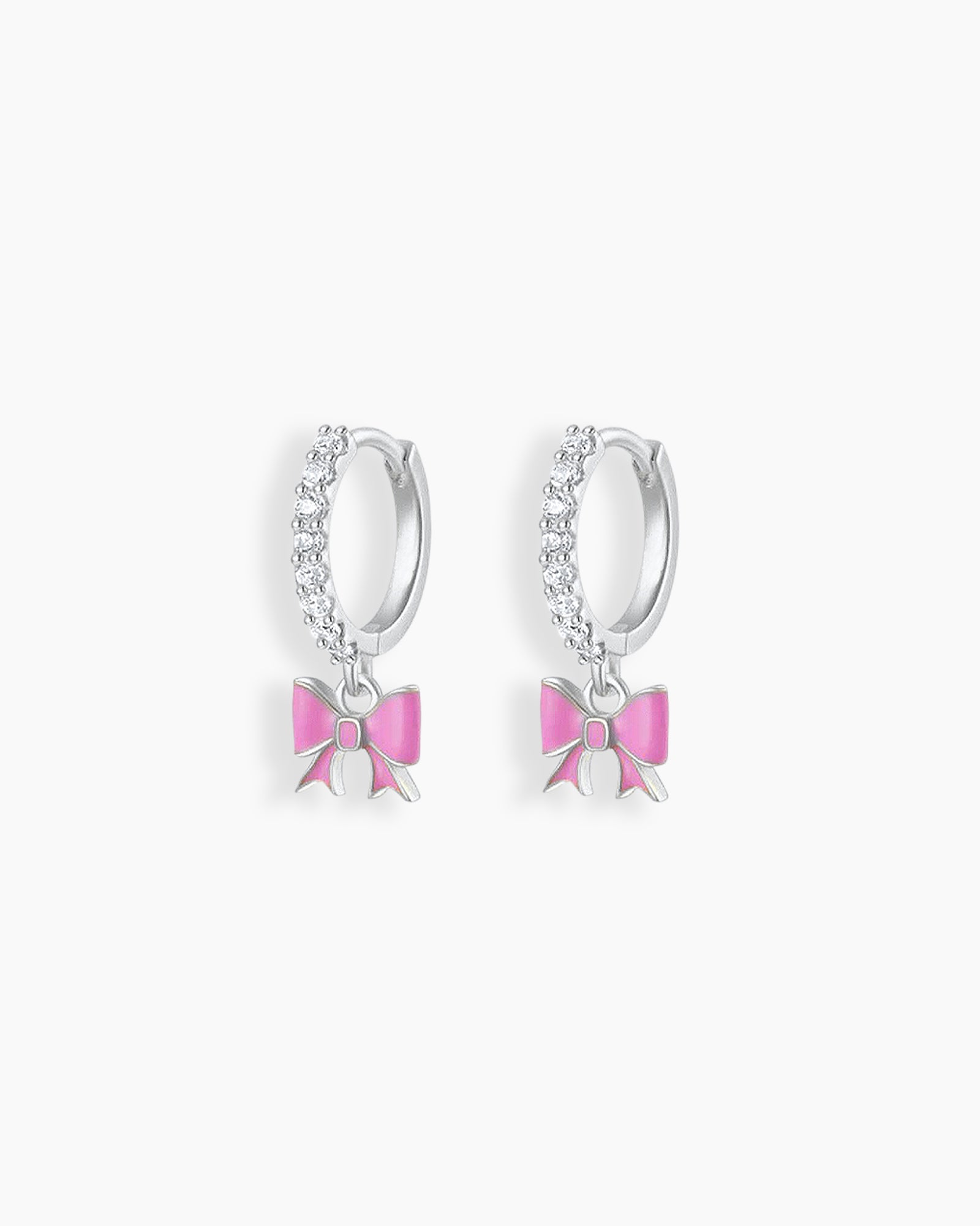 Playful silver hoop earrings with a cascade of cubic zirconia stones and a dangling soft pink enamel bow
