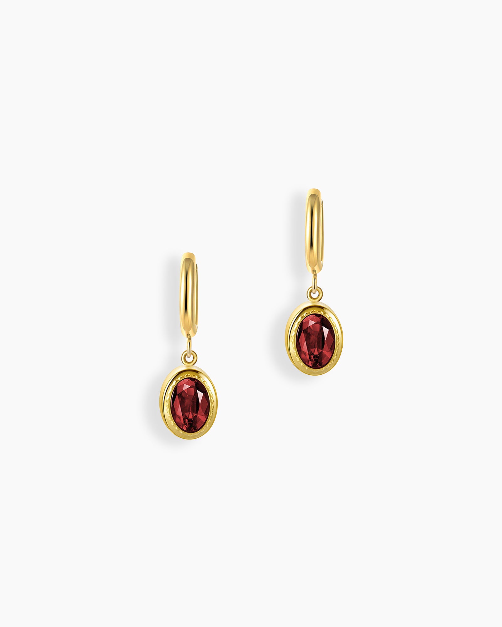 Red stone drop earrings with a richly hued oval-cut zircon in a polished gold bezel