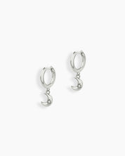Silver drop earrings with polished huggie hoops and crescent moon charms engraved with starbursts