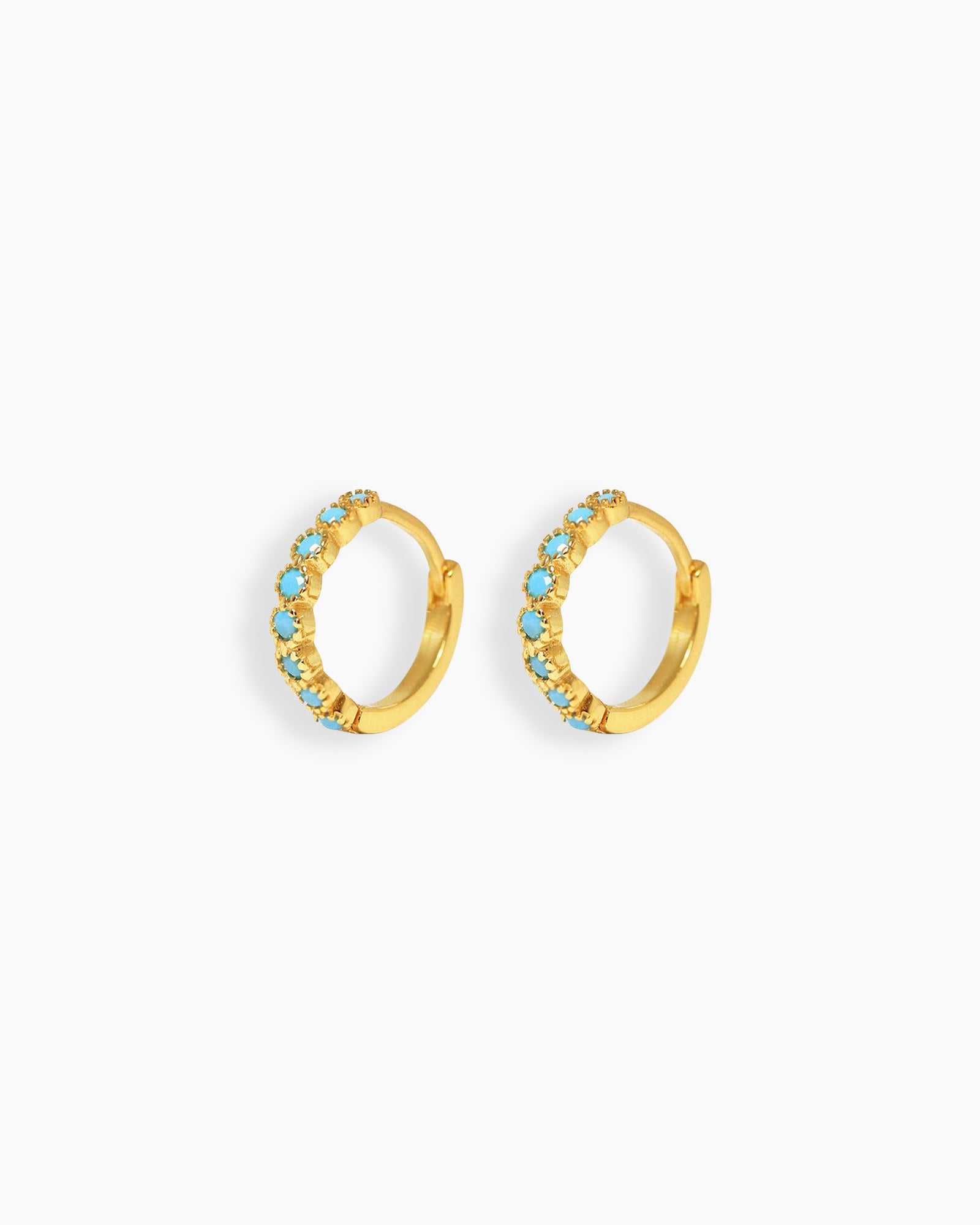 Petite gold-tone hoop earrings set with a delicate line of turquoise-blue stones in a textured setting