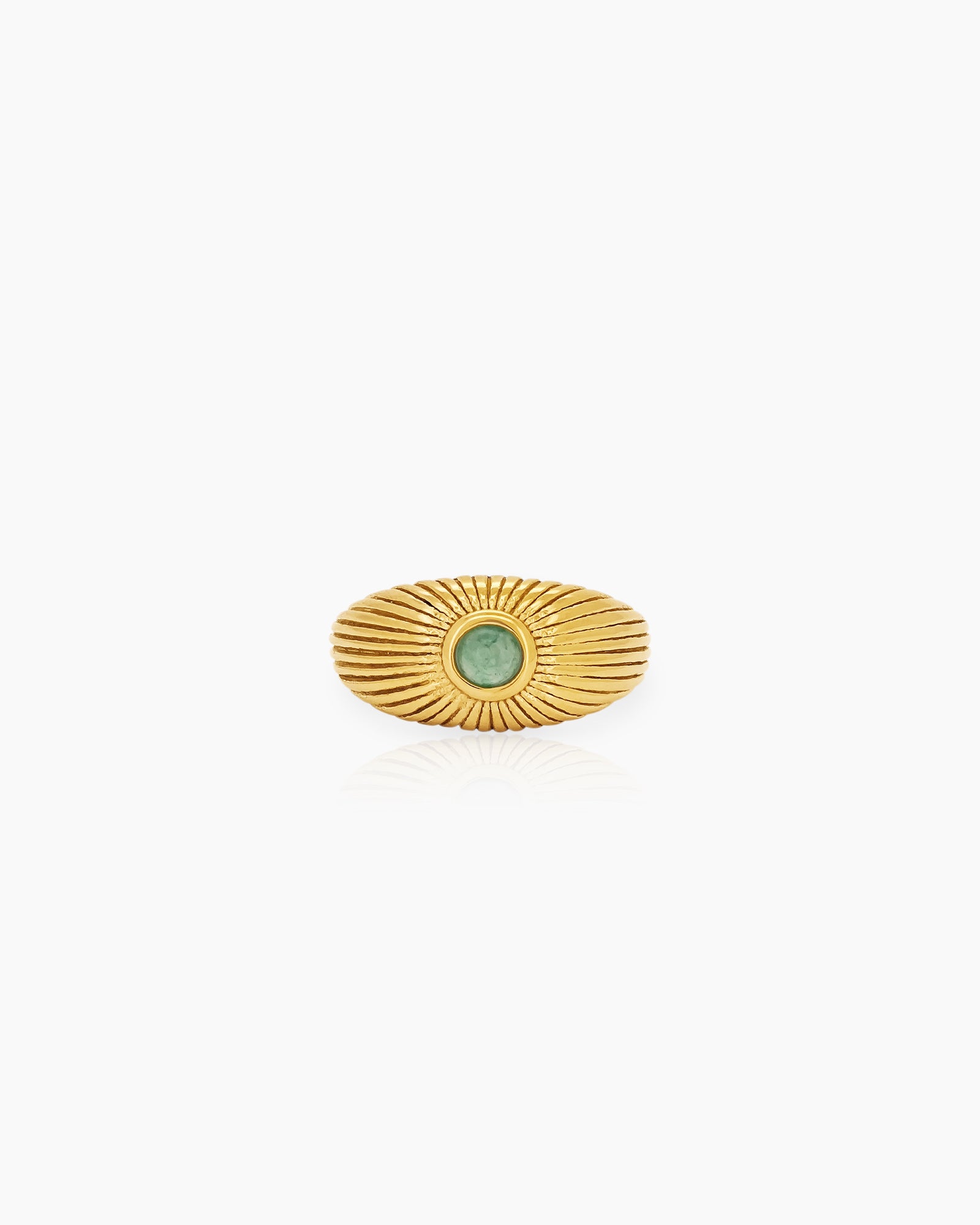 A vintage ring with a ridged gold sunburst-style band radiating around a soft green natural jade stone