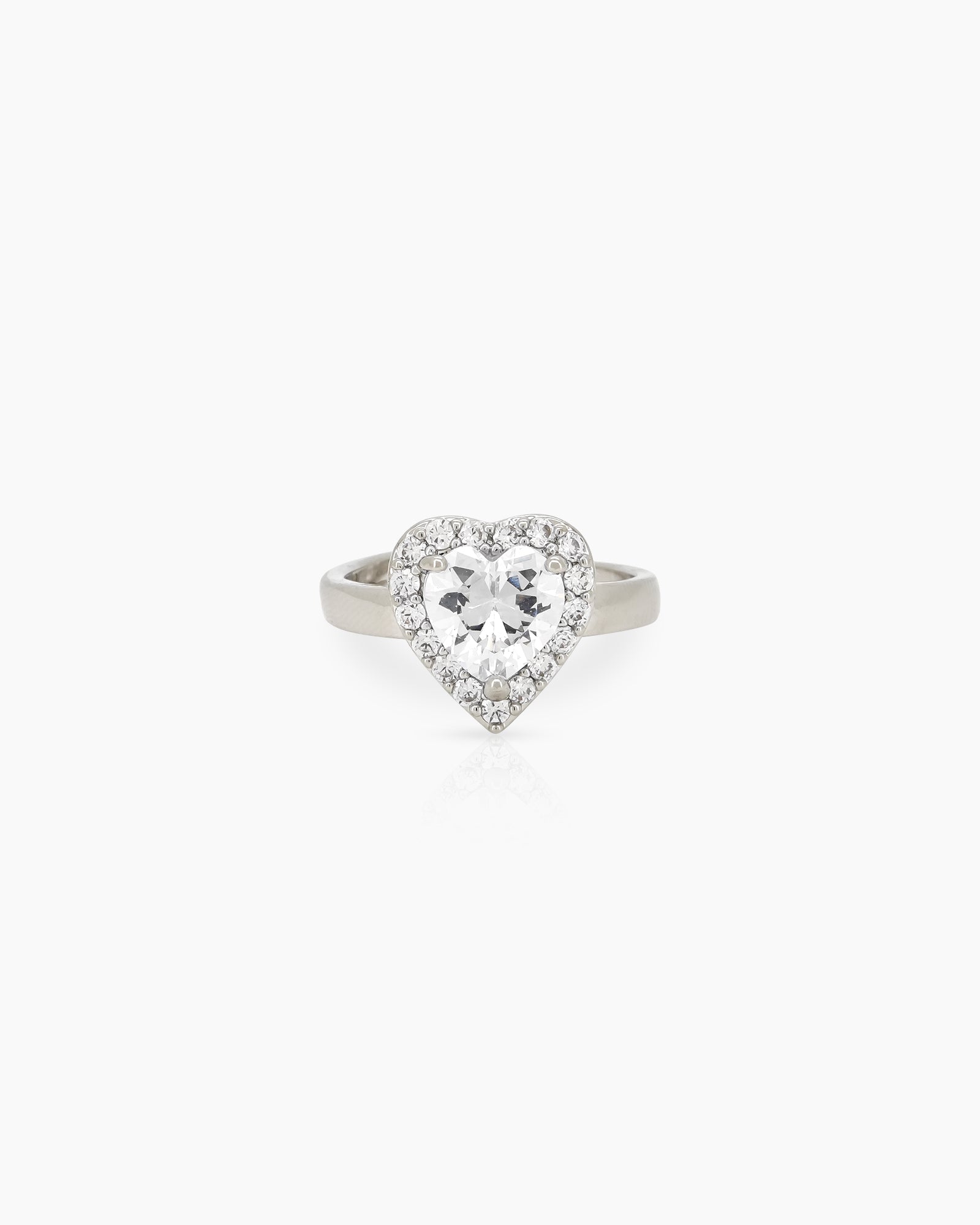 A romantic white ring with a heart-cut zircon stone framed by a border of brilliant pavé crystals