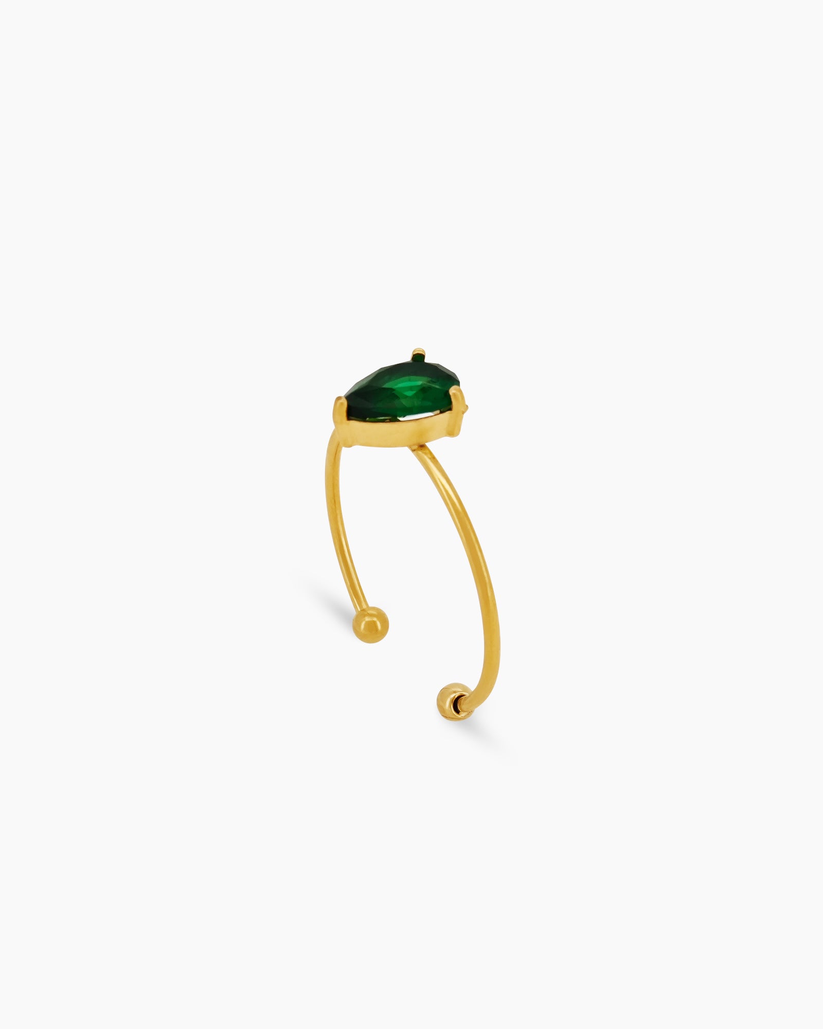 A green ring with an ultra-thin, open gold band and a captivating pear-shaped zircon