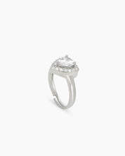 A romantic white ring with a heart-cut zircon stone framed by a border of brilliant pavé crystals