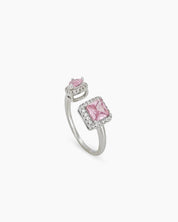 A pink open-front ring with a pavé-framed square-cut zircon and a pear-cut stone for a bold look