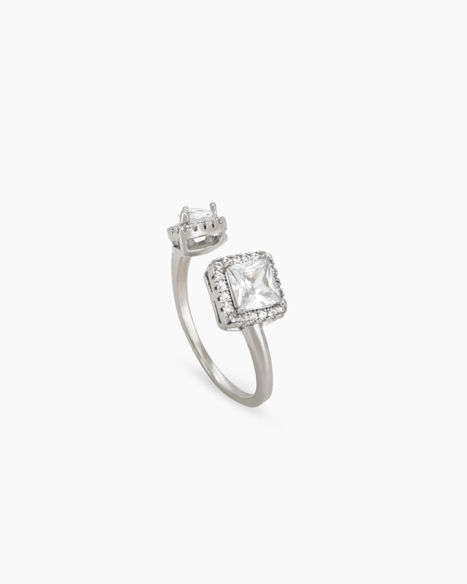 A white open-front ring with a pavé-framed square-cut zircon and a pear-cut stone for a bold look