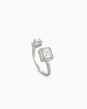A white open-front ring with a pavé-framed square-cut zircon and a pear-cut stone for a bold look