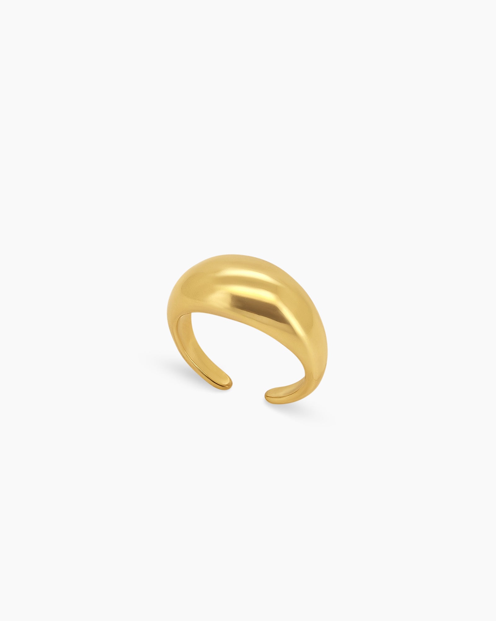 A bold gold ring with a smooth, curved oval form that has a high-gloss surface