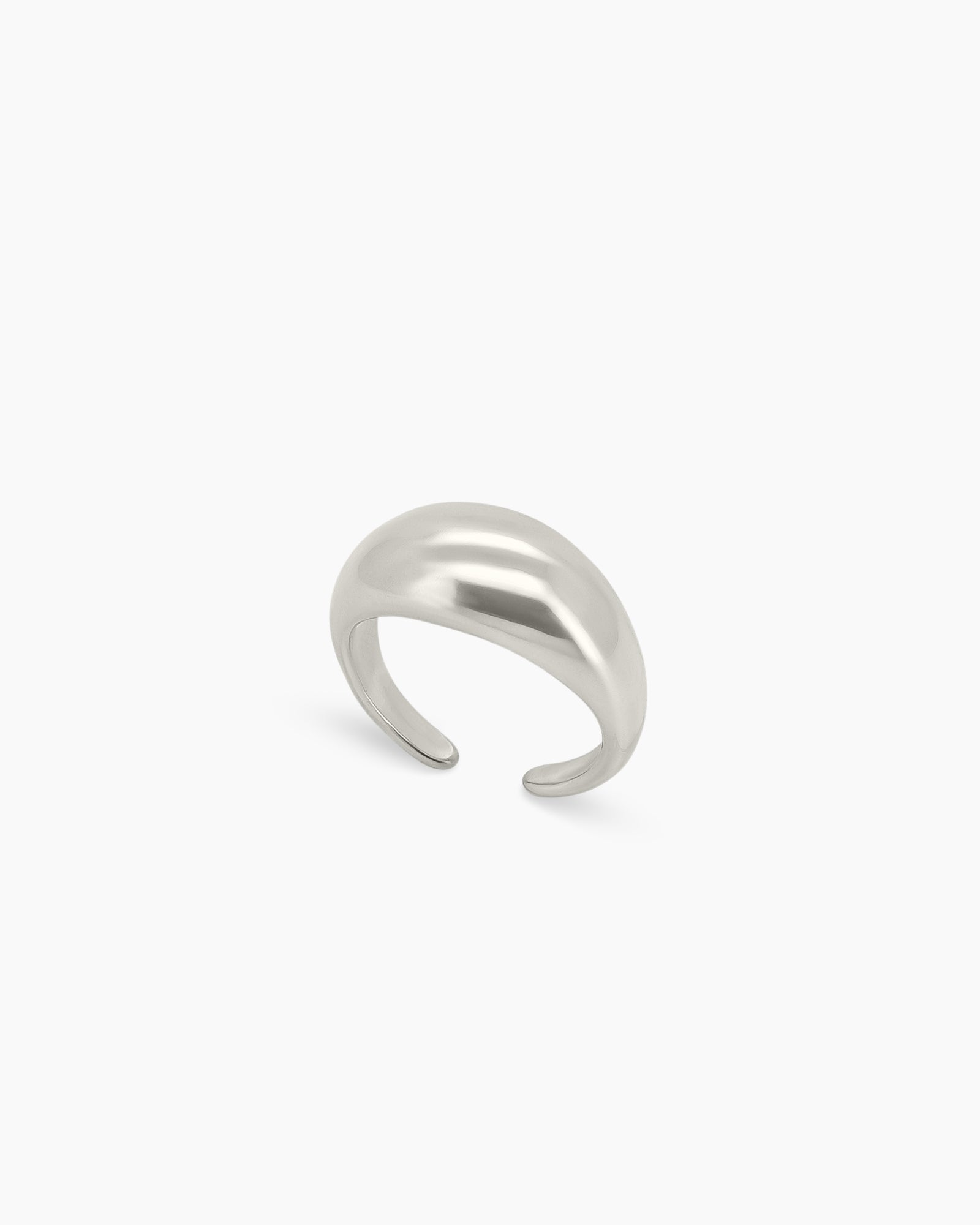 A bold silver ring with a smooth, curved oval form that has a high-gloss surface