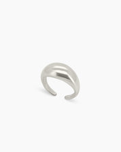 A bold silver ring with a smooth, curved oval form that has a high-gloss surface