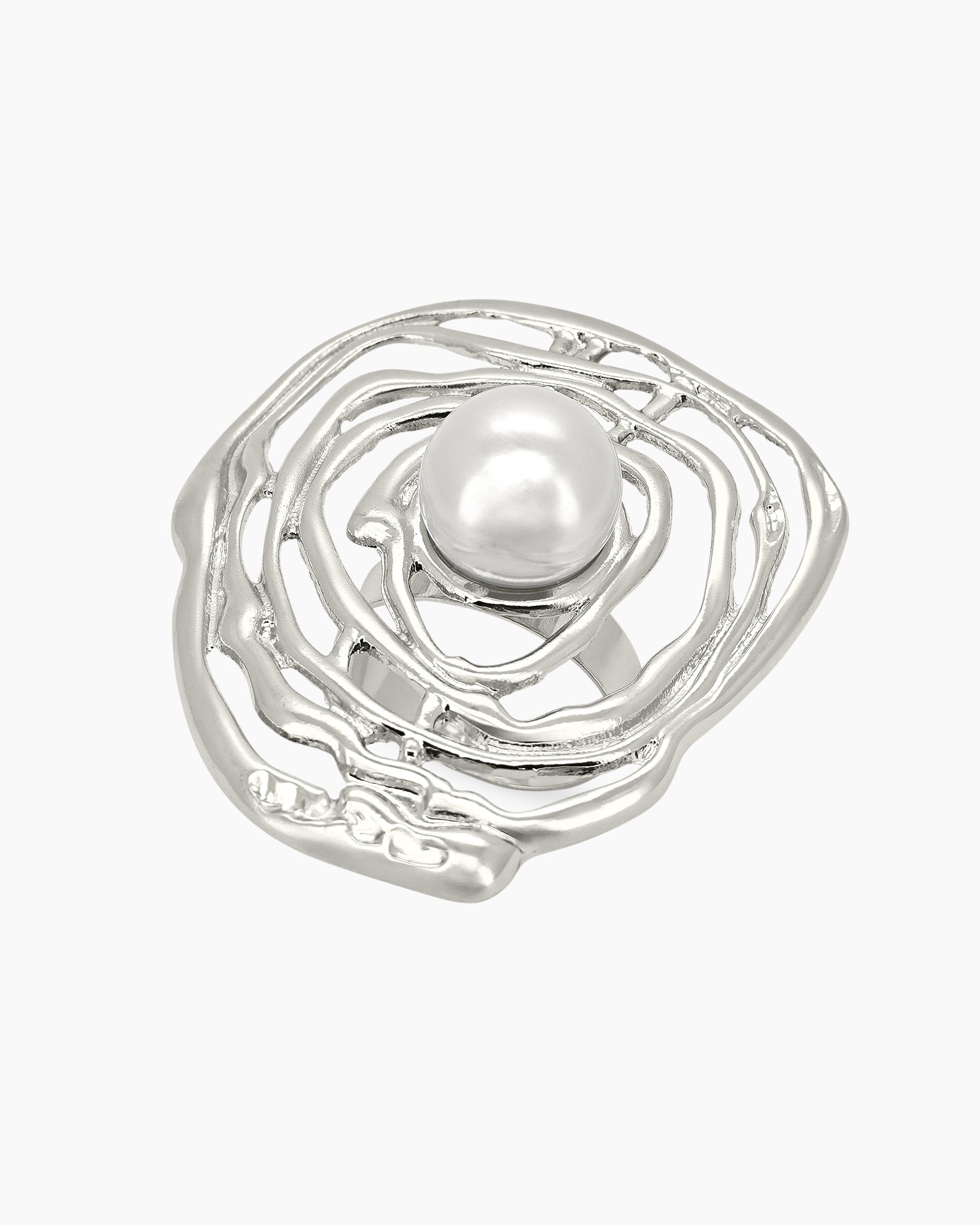 A sculptural silver ring with an abstract shell design cradling a luminous faux pearl