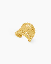 An airy gold statement ring with wavy, openwork bands and an adjustable fit