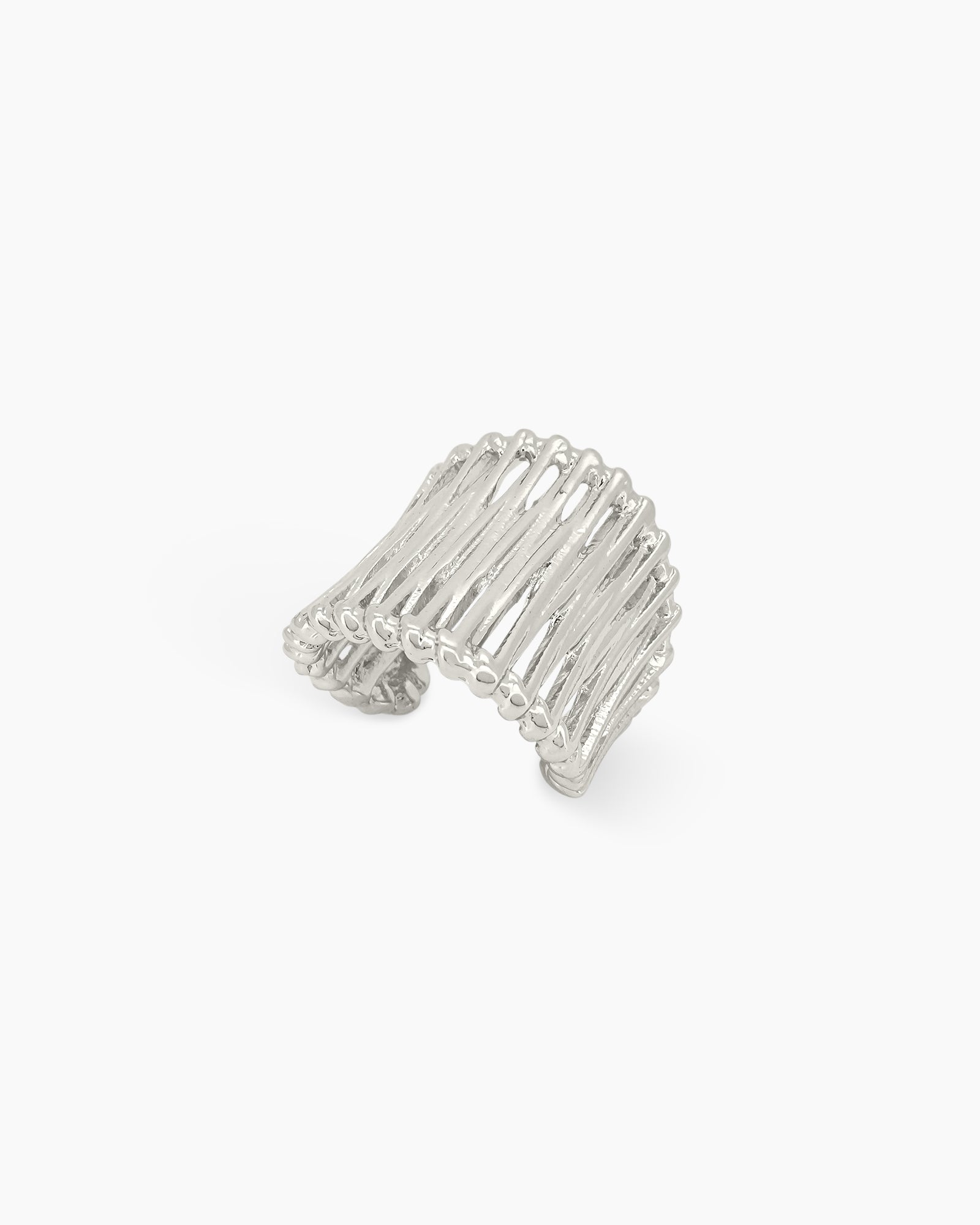 An airy silver statement ring with wavy, openwork bands and an adjustable fit
