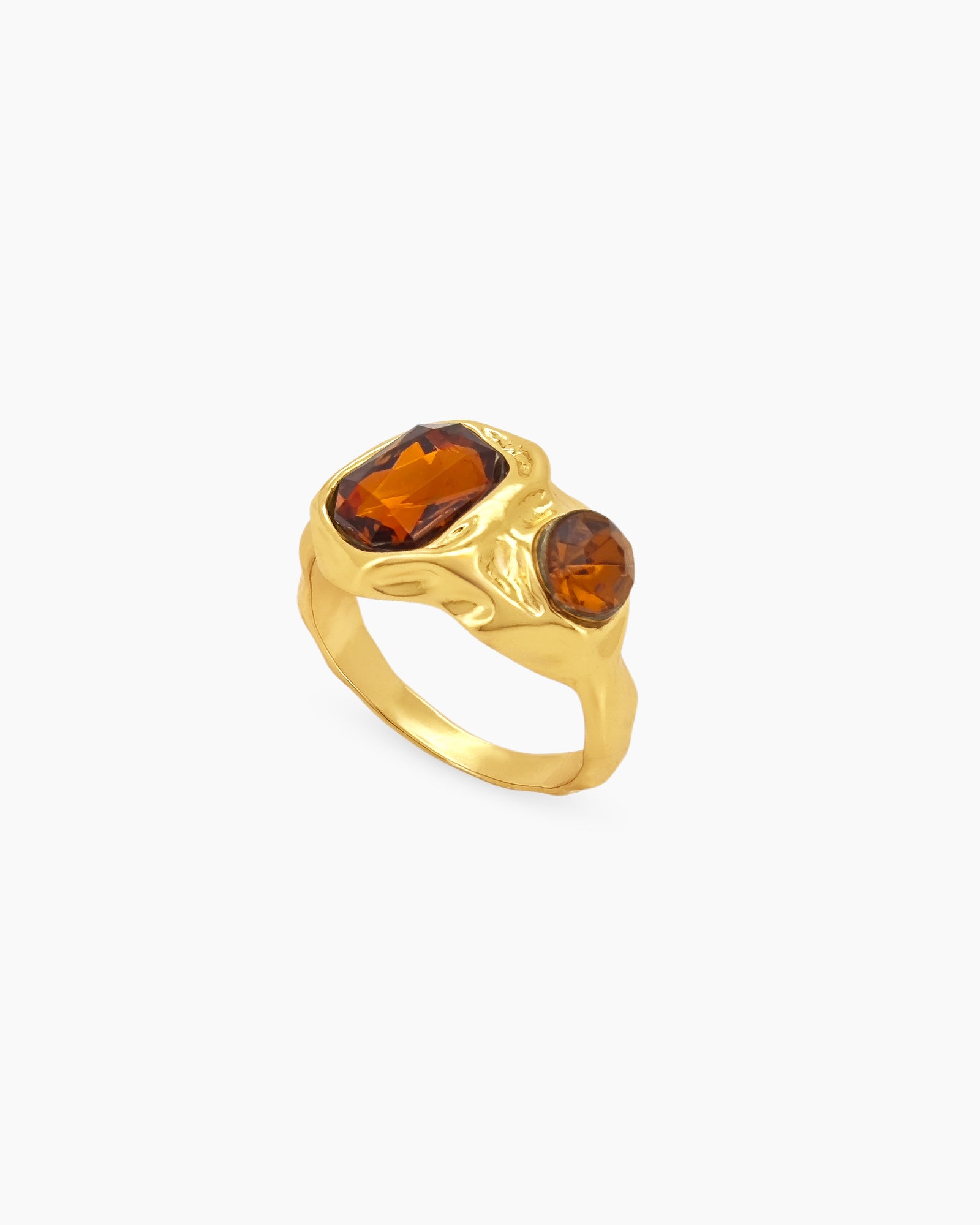 A gold vintage ring with amber-hued rhinestones and an intricately molded, molten-texture band