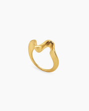A golden ring with a curvy, freeform shape that shines with a polished, playful glow