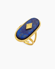 An adjustable ring with a navy lapis lazuli center stone, gold diamond accent, and a polished double band