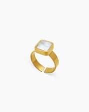 A ring with a square-cut mother-of-pearl inlay, delicately framed in polished gold-tone metal