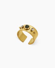 An adjustable ring with a wide, ridged band, a speckled african pine center stone, and zircon accents