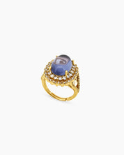 A gold-purple ring with a captivating oval-cut zircon stone surrounded by two halos of shimmering crystals