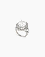 A white ring with a captivating oval-cut zircon stone surrounded by two halos of shimmering crystals