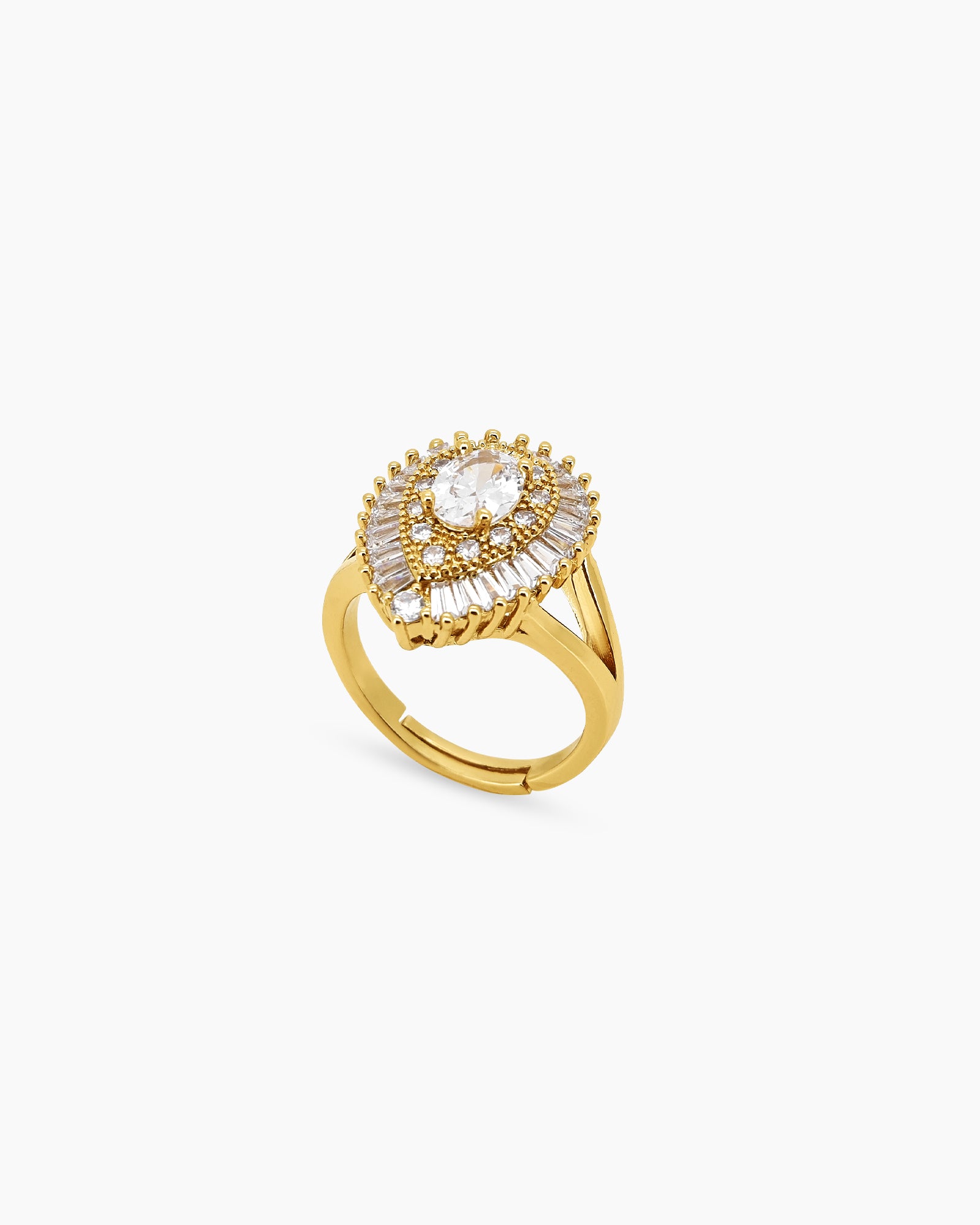 A glamorous gold cocktail ring with a dazzling oval-cut zircon and a double halo of baguette stones