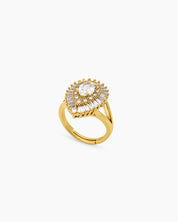 A glamorous gold cocktail ring with a dazzling oval-cut zircon and a double halo of baguette stones