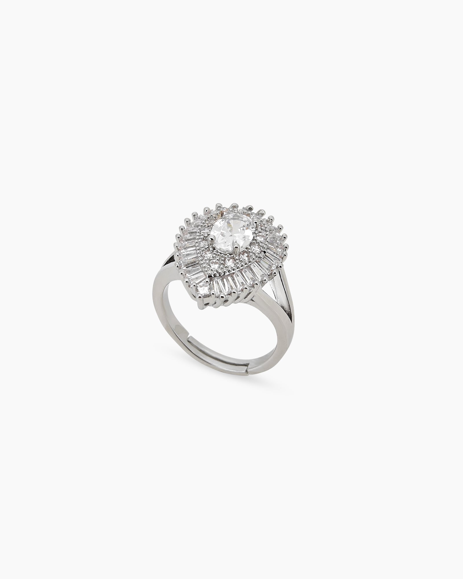 A glamorous silver cocktail ring with a dazzling oval-cut zircon and a double halo of baguette stones