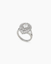A glamorous silver cocktail ring with a dazzling oval-cut zircon and a double halo of baguette stones