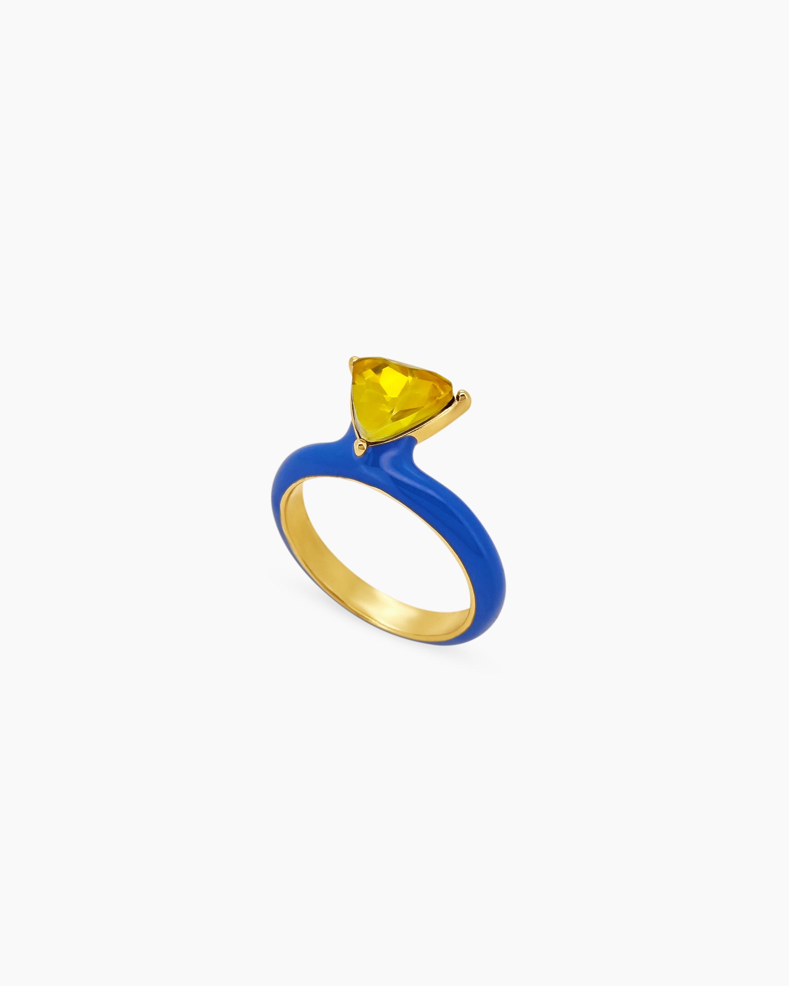 A blue ring with a glossy enamel band and a striking triangular-cut golden yellow gemstone