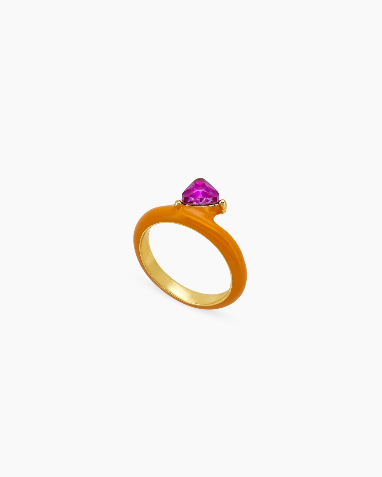 An orange ring with a glossy enamel band and a striking triangular-cut rich fuchsia gemstone